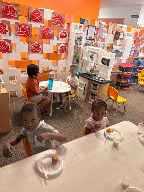 Children enjoying a muffin snack in the classroom