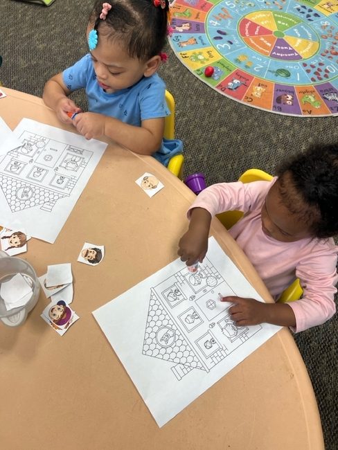 Two toddlers working on a picture matching activity