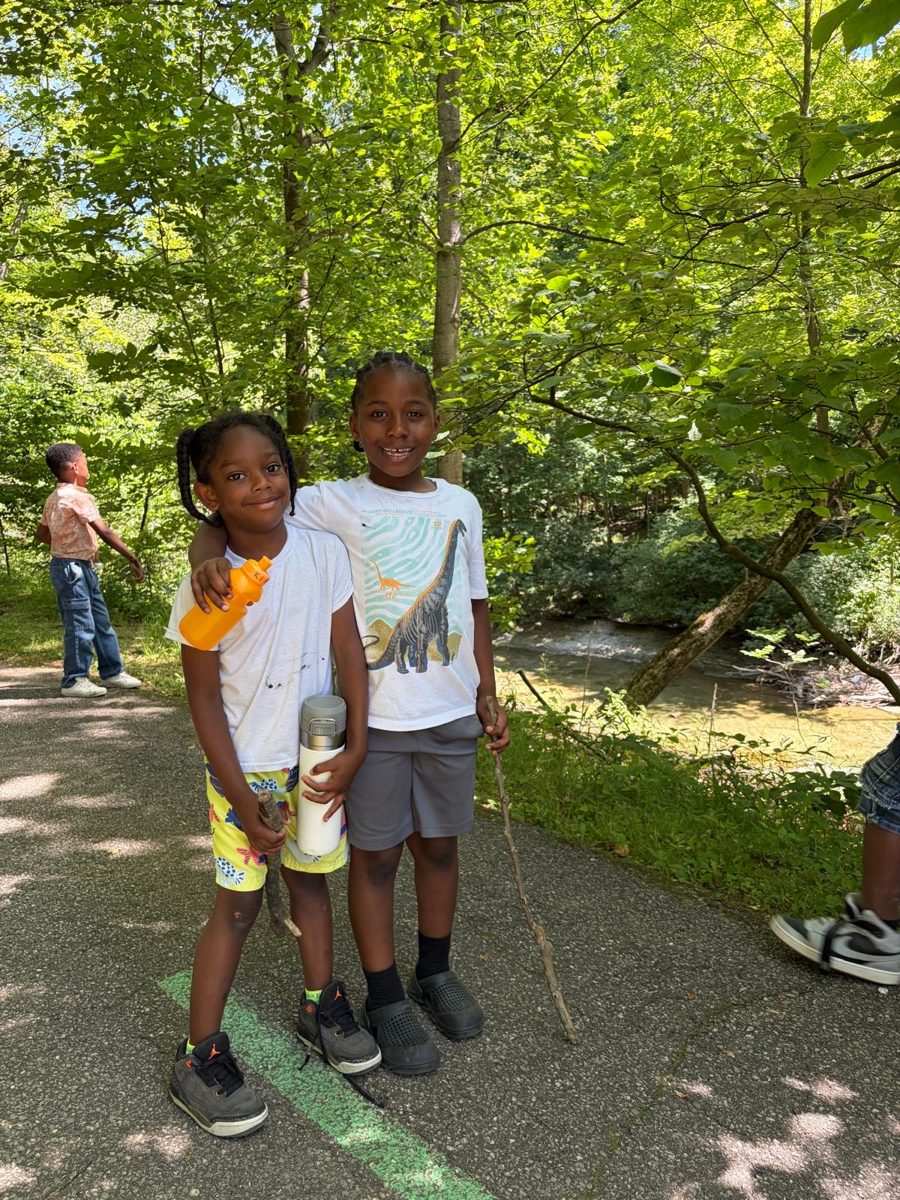 Two friends on a nature walk beside a creek